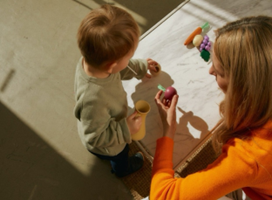 Adult playing with small child offering them choice with what to play with - in relation to pathological demand avoidance where choice rather than demand is often better